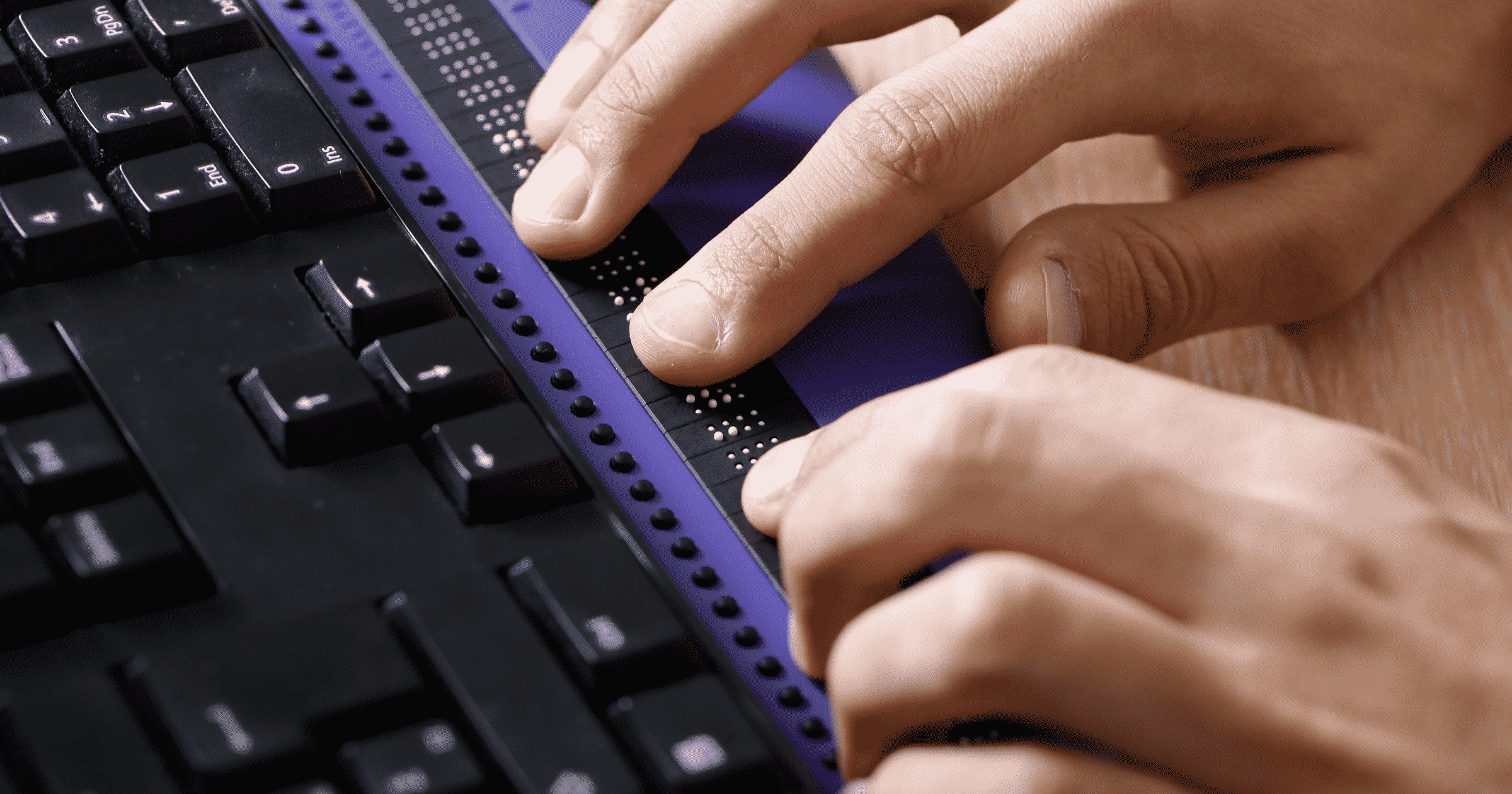 Person using Braille adaptive technology. Why Should your Website be ADA Compliant Blog